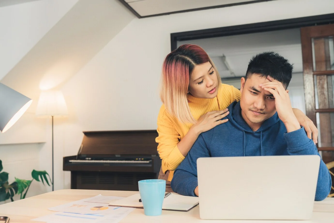 Couple using a laptop to check their mortgage stress test numbers